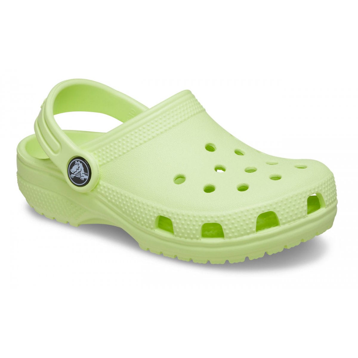 a child's green clogs with holes
